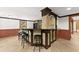 Finished basement bar with dark wood accents, tiled flooring and additional seating at 3260 Governors Court Ct, Duluth, GA 30096