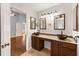 Bathroom with double sink vanity, bronze vessel sinks and wood cabinets at 3260 Governors Court Ct, Duluth, GA 30096