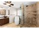 Updated bathroom features tile shower with glass door and a freestanding bathtub at 3260 Governors Court Ct, Duluth, GA 30096