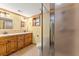Bathroom with double sinks, wood cabinets and framed mirrors at 3260 Governors Court Ct, Duluth, GA 30096