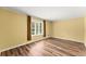 Cozy bedroom with hardwood floors and natural light from a large window at 3260 Governors Court Ct, Duluth, GA 30096