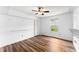 Bright bedroom with hardwood floors, ceiling fan, shelving and a window with natural light at 3260 Governors Court Ct, Duluth, GA 30096