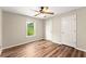 Neutral bedroom featuring modern ceiling fan, vinyl wood floors and a window at 3260 Governors Court Ct, Duluth, GA 30096