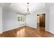 Bright dining room with hardwood floors, modern chandelier, and view to a barn door at 3260 Governors Court Ct, Duluth, GA 30096
