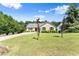 Attractive brick home featuring a green lawn and driveway with green foliage at 3260 Governors Court Ct, Duluth, GA 30096