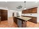 Well-appointed kitchen with island, stainless steel appliances and terra cotta floors at 3260 Governors Court Ct, Duluth, GA 30096