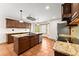 Well lit kitchen with terra cotta floors, island, stainless steel appliances and granite countertops at 3260 Governors Court Ct, Duluth, GA 30096