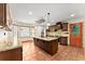 Open kitchen with stainless steel appliances, custom cabinetry and a granite countertop island at 3260 Governors Court Ct, Duluth, GA 30096