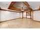 Spacious basement living room featuring a decorative wood ceiling, tiled flooring, and recessed lights at 3260 Governors Court Ct, Duluth, GA 30096