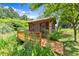 A small, rustic outbuilding with a wood deck and natural landscaping at 3260 Governors Court Ct, Duluth, GA 30096