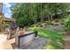 Landscaped backyard with seating area, outdoor kitchen, and terraced garden at 109 Bellehaven Dr, Woodstock, GA 30188