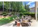 Private backyard patio area with outdoor seating and a landscaped yard with lush greenery at 109 Bellehaven Dr, Woodstock, GA 30188