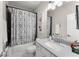 Bathroom with tub and shower combo, updated vanity, and modern fixtures at 109 Bellehaven Dr, Woodstock, GA 30188