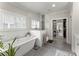 Bright bathroom boasts a soaking tub, glass enclosed shower, and access to the walk-in closet at 109 Bellehaven Dr, Woodstock, GA 30188