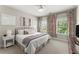 Bright bedroom features a comfortable bed and stylish decor, windows, and a ceiling fan at 109 Bellehaven Dr, Woodstock, GA 30188
