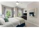Bright bedroom features a comfortable bed and stylish decor, windows, and a ceiling fan at 109 Bellehaven Dr, Woodstock, GA 30188