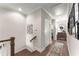 Hallway with stairs leading to the second floor with view into the laundry room at 109 Bellehaven Dr, Woodstock, GA 30188