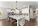 Bright, modern kitchen with a large center island, white cabinets, and stainless steel appliances at 109 Bellehaven Dr, Woodstock, GA 30188