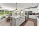 Open kitchen with an island, stainless appliances, and an attached living area with access to the backyard at 109 Bellehaven Dr, Woodstock, GA 30188
