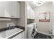 The laundry room features modern appliances, ample storage, and a utility sink at 109 Bellehaven Dr, Woodstock, GA 30188