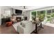 Open living room with a fireplace, hardwood floors, and a sliding glass door to the outdoor patio at 109 Bellehaven Dr, Woodstock, GA 30188