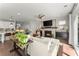 Open-concept living room showcasing a stone fireplace, TV, and seamless flow to the kitchen and outdoor space at 109 Bellehaven Dr, Woodstock, GA 30188