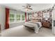 Inviting main bedroom with floral wallpaper, ample natural light, ceiling fan and ensuite bathroom at 109 Bellehaven Dr, Woodstock, GA 30188