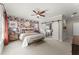 Inviting main bedroom with a floral accent wall, ceiling fan, and ensuite bathroom with sliding doors at 109 Bellehaven Dr, Woodstock, GA 30188