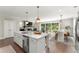 Spacious open layout including a kitchen with island, dining area, and access to outdoor patio at 109 Bellehaven Dr, Woodstock, GA 30188