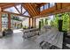Outdoor kitchen and dining area with wooden tables and grill at 109 Bellehaven Dr, Woodstock, GA 30188
