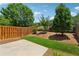 Beautiful backyard with a patio, lawn, wood fence and well-manicured landscaping at 2058 Glenview Park Cir, Duluth, GA 30097