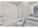 Bright bathroom with a white subway tile shower over the tub and gray vanity at 2058 Glenview Park Cir, Duluth, GA 30097