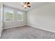 Bright bedroom with neutral carpet and two large windows offering ample natural light at 2058 Glenview Park Cir, Duluth, GA 30097