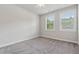 Bright bedroom with neutral carpet and two large windows offering ample natural light at 2058 Glenview Park Cir, Duluth, GA 30097