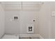 Neutral laundry room featuring utility connections, a wire shelf and clean white walls at 2058 Glenview Park Cir, Duluth, GA 30097
