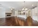 Spacious living room with a stone fireplace and open kitchen, perfect for entertaining at 2058 Glenview Park Cir, Duluth, GA 30097