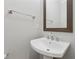 Charming powder room with a pedestal sink, framed mirror and gray walls at 2058 Glenview Park Cir, Duluth, GA 30097