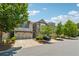 Inviting townhomes line the street with lush trees, manicured landscaping, and two-car garages at 2058 Glenview Park Cir, Duluth, GA 30097
