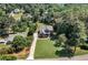 Aerial view shows the lake access with cove and kayak launch from property, nestled among mature trees at 7125 Heard Rd, Cumming, GA 30041