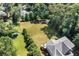 Aerial view revealing kayak/canoe launch area, expansive lawn and privacy at 7125 Heard Rd, Cumming, GA 30041