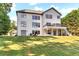 Expansive backyard featuring a well-maintained lawn, deck, and patio ideal for outdoor living at 7125 Heard Rd, Cumming, GA 30041