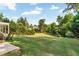 Expansive backyard featuring a manicured lawn, mature trees, and a view of the surrounding landscape at 7125 Heard Rd, Cumming, GA 30041