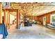 Unfinished basement featuring an open layout, exposed wood framing, and walkout access to the outdoors at 7125 Heard Rd, Cumming, GA 30041