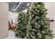Storage area in an unfinished basement with several pre-lit Christmas trees stored for the holiday season at 7125 Heard Rd, Cumming, GA 30041