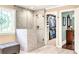 A modern bathroom with marble shower, glass door, and access to the walk-in closet at 7125 Heard Rd, Cumming, GA 30041
