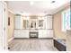 Luxurious bathroom with double vanity, custom cabinets, modern lighting fixtures, and spacious shower at 7125 Heard Rd, Cumming, GA 30041