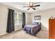 Bedroom featuring a single bed with a ceiling fan, curtains, and a window with a view at 7125 Heard Rd, Cumming, GA 30041