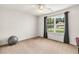Bright bedroom with carpet flooring, a ceiling fan, and large windows with views at 7125 Heard Rd, Cumming, GA 30041
