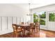 Dining room with hardwood floors, a large window, and a wooden table with seating for six at 7125 Heard Rd, Cumming, GA 30041