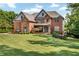 Beautiful brick two-story home with manicured lawn and tasteful landscaping at 7125 Heard Rd, Cumming, GA 30041